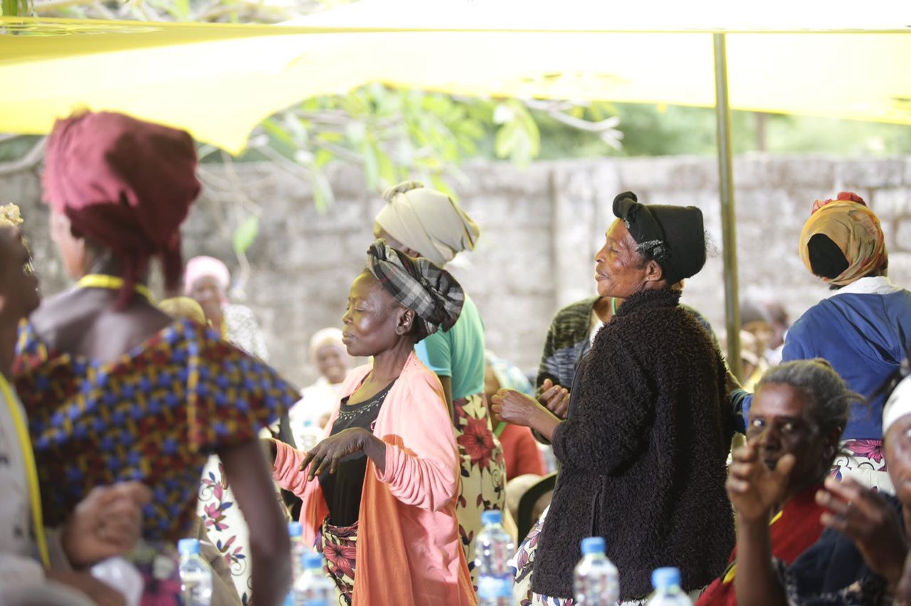 Elderly women dancing and socializing.